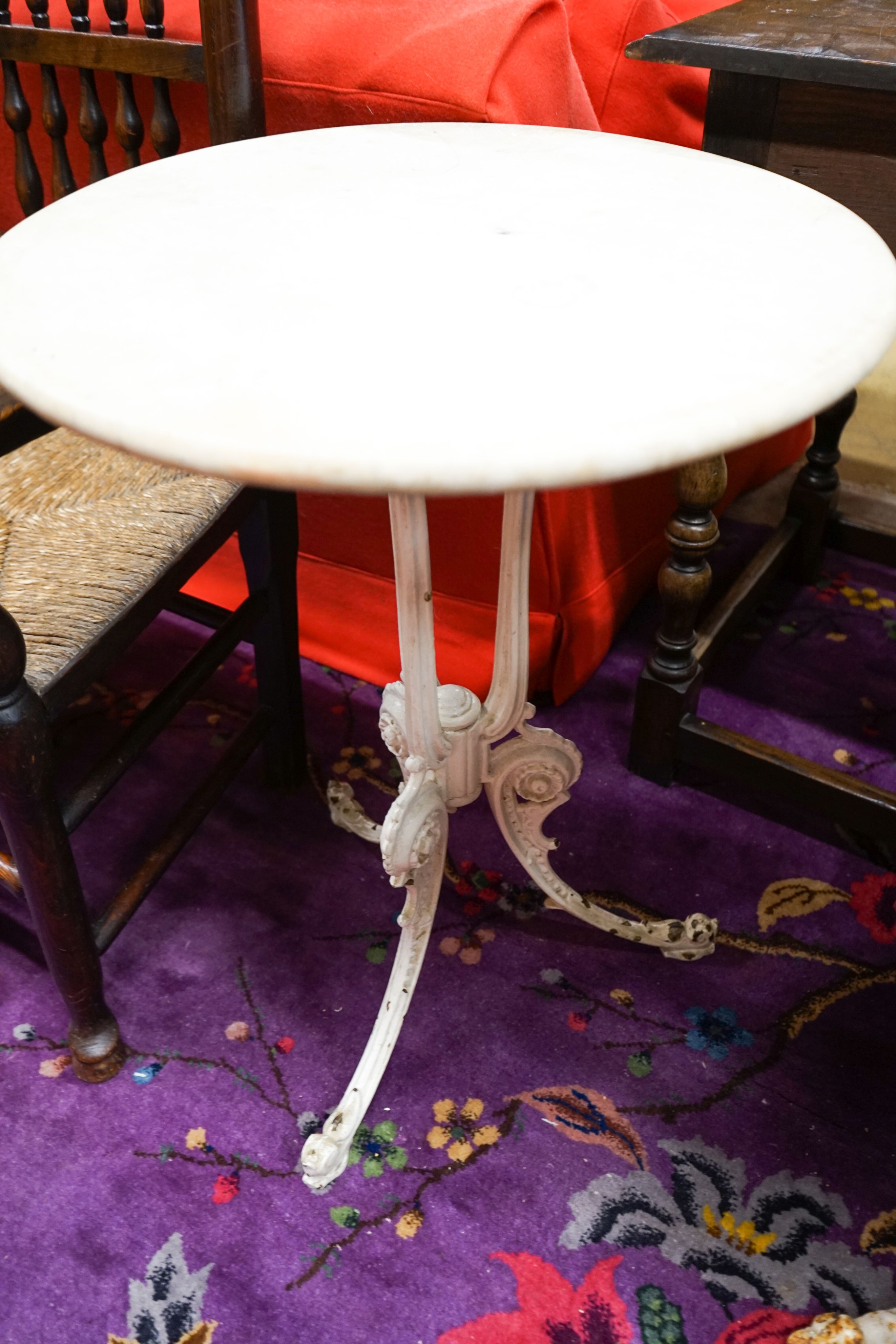 A near pair of painted cast iron circular marble top tables, larger 60cm diameter, height 71cm